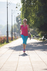 Image showing sporty woman running  on sidewalk