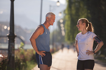 Image showing jogging couple planning running route  and setting music