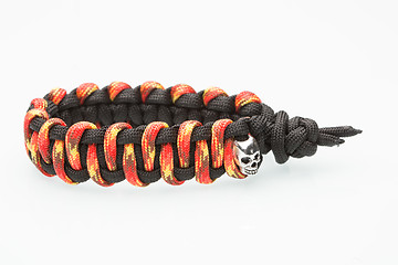 Image showing black and orange braided bracelet on white background