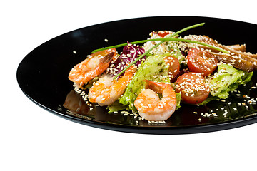 Image showing perfect dish with shrimps on a black plate. seafood. Isolated  white background