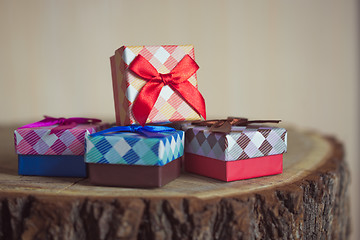 Image showing Gift box with red bow on wood background