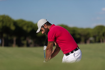 Image showing golfer hitting a sand bunker shot