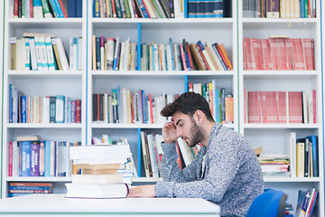 Image showing portrait of student while reading book  in school library