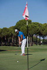 Image showing golf player hitting shot at sunny day