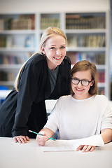 Image showing female teacher helping students on class