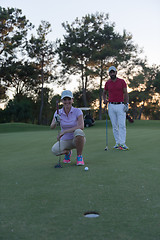 Image showing couple on golf course at sunset