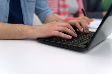Image showing close up of student hands typing on laptop
