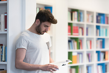 Image showing student in school library using tablet for research