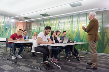 Image showing teacher with a group of students in classroom