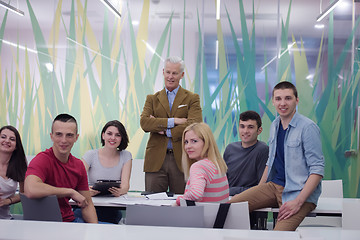 Image showing portrait of  teacher with students group in background