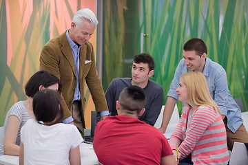 Image showing teacher with a group of students in classroom