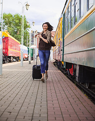 Image showing woman with luggage on the station platform