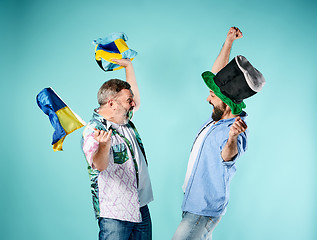 Image showing The two football fans with a flag of Ukraine over blue