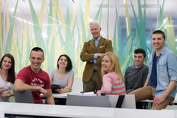 Image showing portrait of  teacher with students group in background