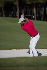 Image showing golfer hitting a sand bunker shot