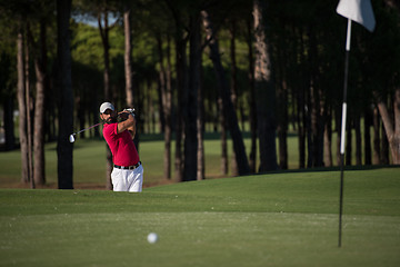 Image showing golfer hitting a sand bunker shot