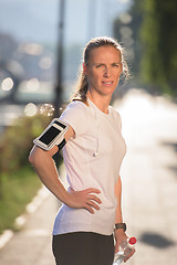 Image showing woman drinking  water after  jogging