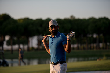 Image showing golfer  portrait at golf course on sunset