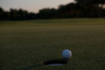 Image showing golf ball on edge of  the hole