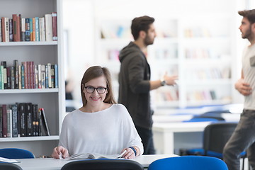 Image showing female student study in school library, group of students in bac