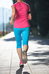 Image showing sporty woman running  on sidewalk