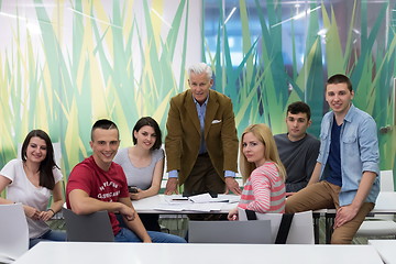 Image showing portrait of  teacher with students group in background