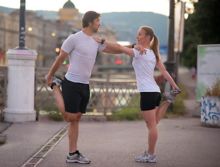 Image showing couple warming up before jogging