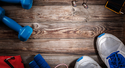 Image showing Sport stuff on wooden table, top view