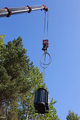 Image showing Crane hook lifts up the power transformer