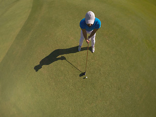 Image showing top view of golf player hitting shot