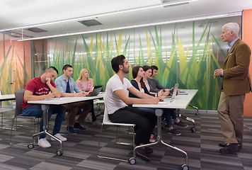 Image showing teacher with a group of students in classroom