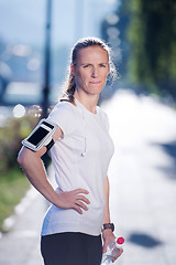 Image showing woman drinking  water after  jogging