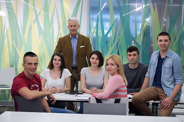 Image showing portrait of  teacher with students group in background