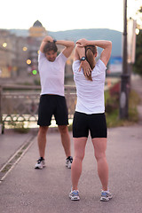 Image showing couple warming up before jogging