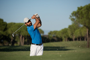 Image showing pro golfer hitting a sand bunker shot