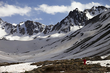 Image showing Hiker in spring snowy mountains