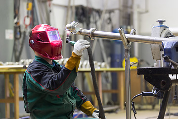 Image showing Industrial worker welding in metal factory.