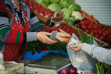 Image showing woman buys vegetables at a market