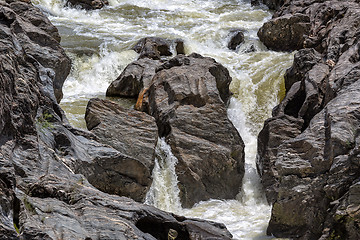 Image showing Waterfall Flowing Between the Lava Stones