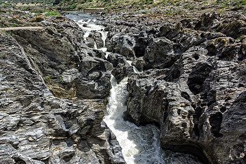 Image showing Waterfall Flowing Between the Lava Stones