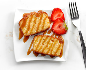 Image showing biscuit cake slices decorated with caramel sauce