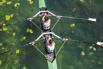 Image showing Two rowers  rowing