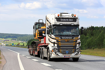 Image showing Customized Scania R560 Semi Hauls Excavator along Freeway