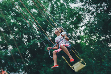 Image showing girl riding on chained carousel