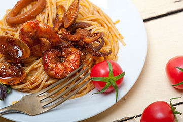 Image showing Italian seafood spaghetti pasta on red tomato sauce 