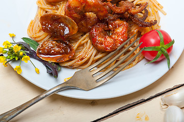 Image showing Italian seafood spaghetti pasta on red tomato sauce 