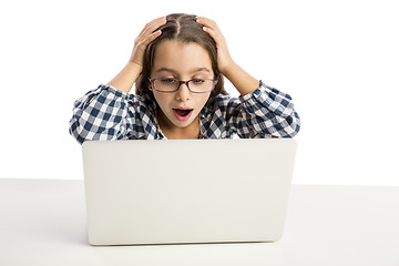 Image showing Little girl working with a laptop