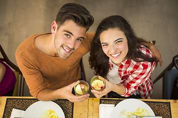 Image showing Young couple toasting