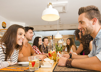 Image showing Friends lunching at the restaurant