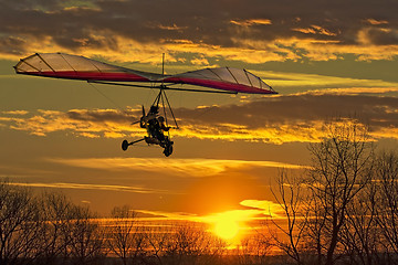 Image showing Hang glider fly in the sunset 